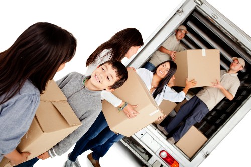 Removal team handling boxes and furniture during a Hampstead house move