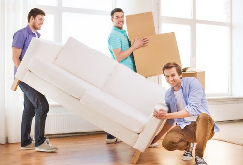 Packed moving boxes ready in a Hampstead property entrance