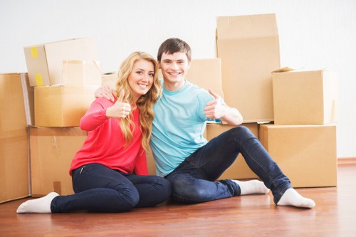 Movers handling furniture in a Hampstead flat with narrow access